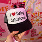 I Love Being Delusional Black/White Trucker Hat